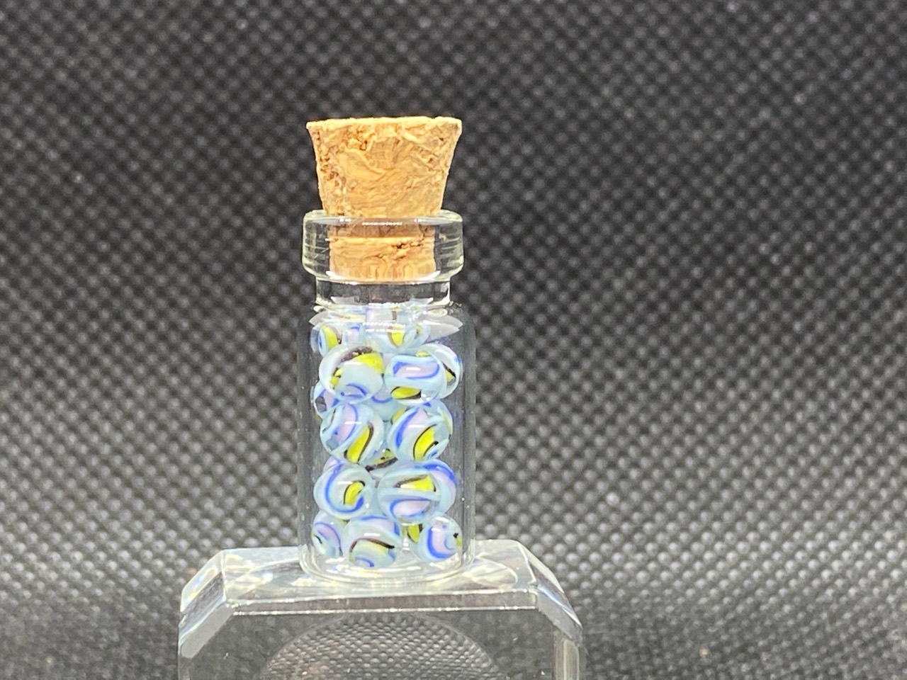 Blue, Lavender & Lemon Mini Micro Marbles: Studio bottle view showing pale blue and lavender ribbons with lemon-yellow accents