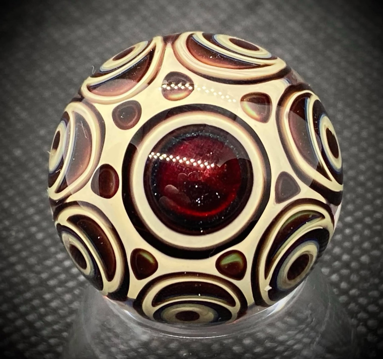 Dot Stack Marble — Over 75 Dots: cream-colored concentric rings surrounding deep ruby centers