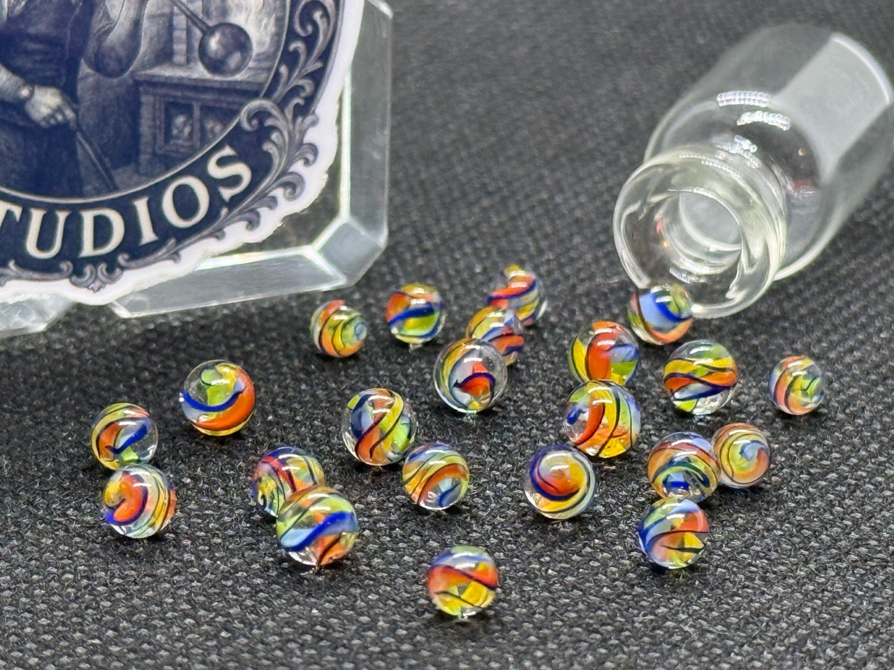 Electric Rainbow Mini Micro Marbles showing rainbow glass ribbons in ordinary light