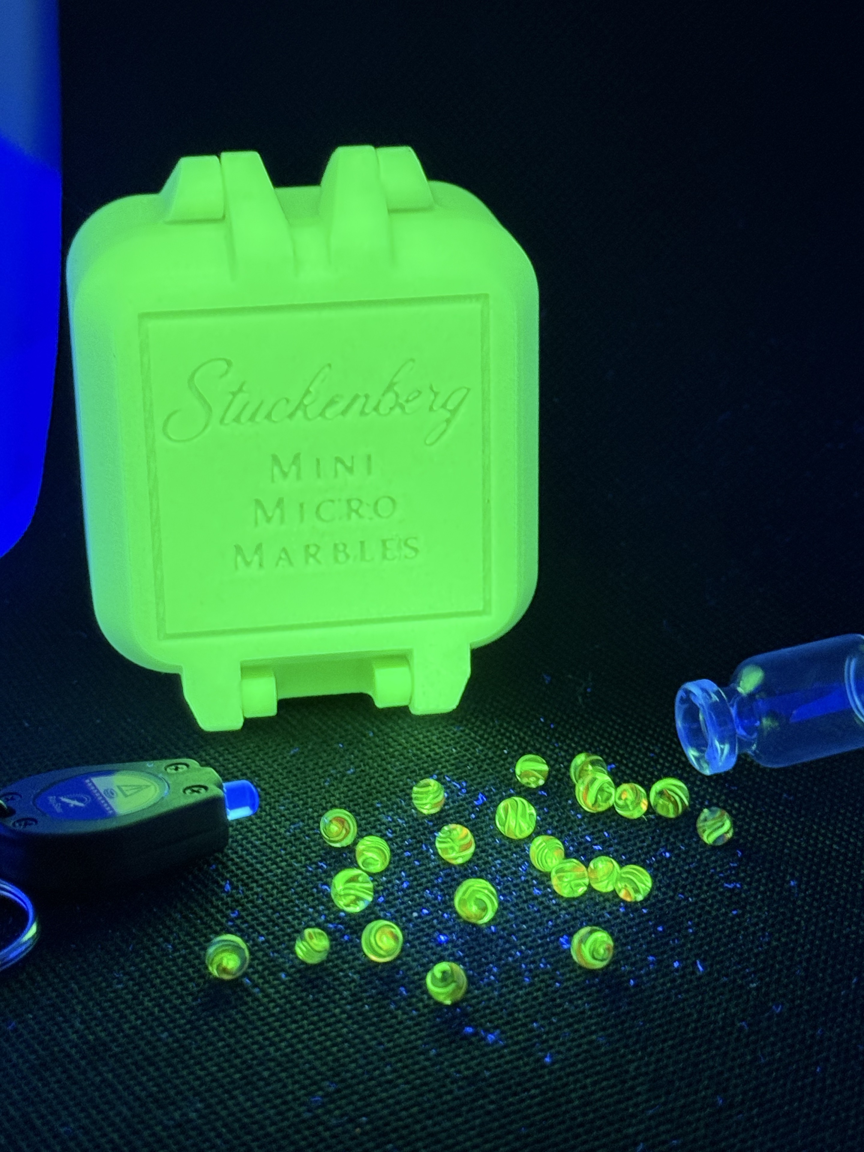 Electric Rainbow Mini Micro Marbles, black light keychain and glowing display box under UV light