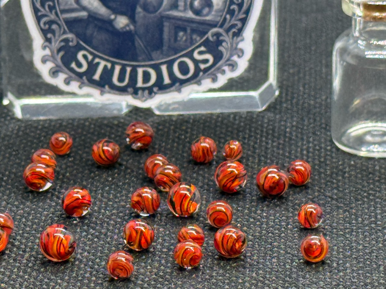 Fine dark lines and deep layered ribbons in loose Fire Brick Ribbon Mini Micro Marbles