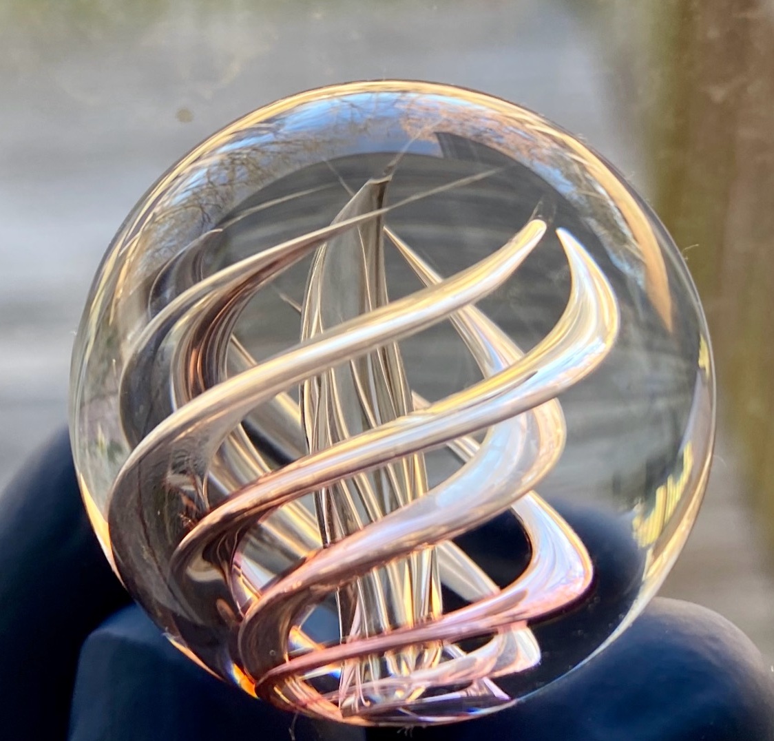 Gold Fume Air Trap: Gold-fumed spiraling air traps glowing rose and gold in natural light