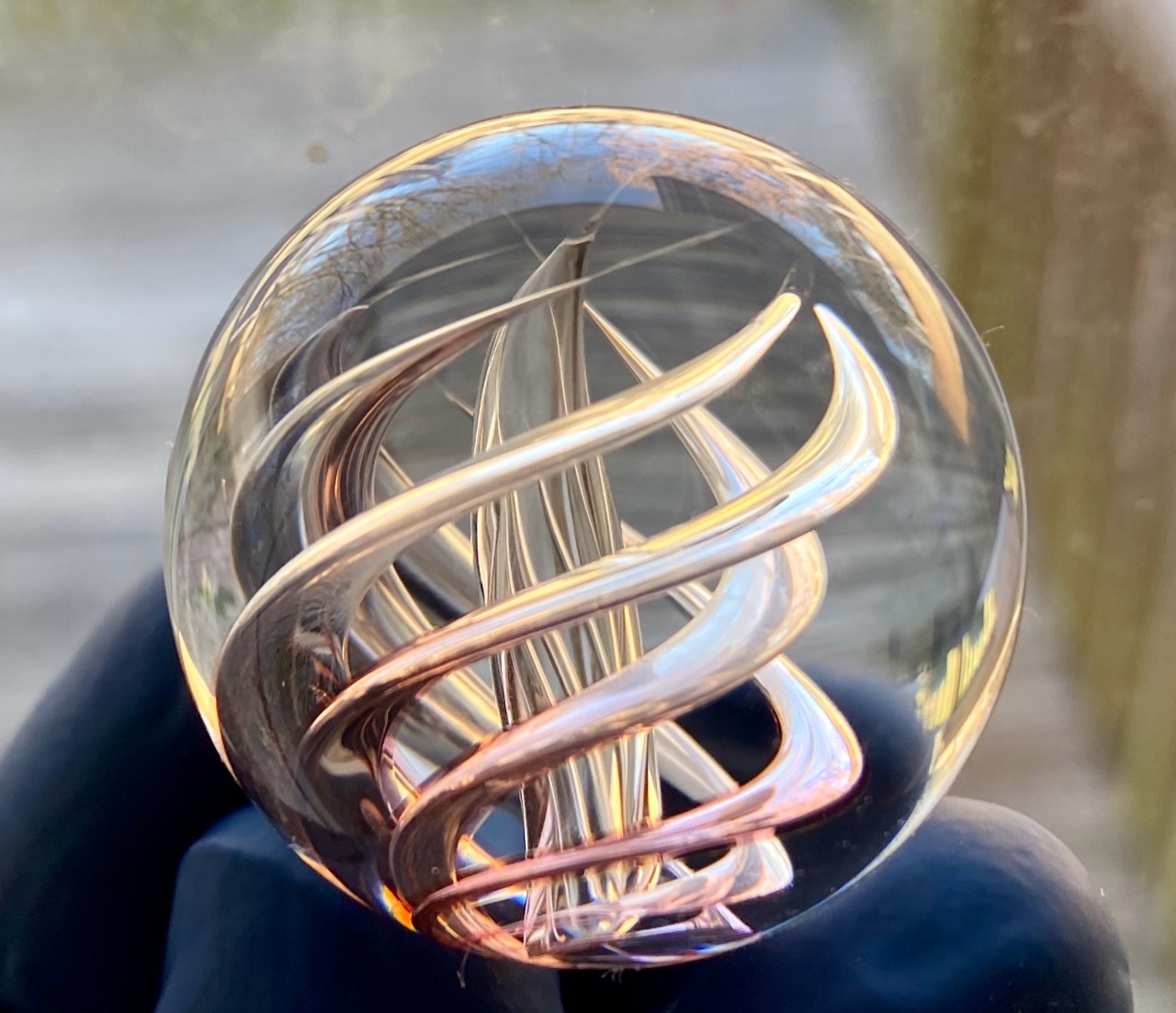 Gold Fume Air Trap: Gold-fumed spiraling air traps glowing rose and gold in natural light