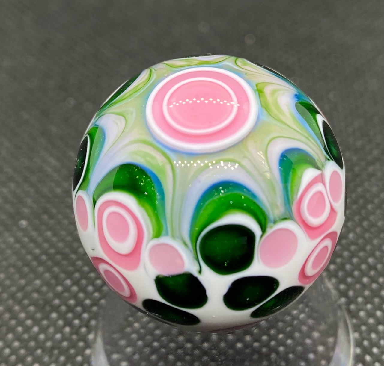 Green and Pink Dot Stack Marble: pink and white dot stacks among deep green forms and pale flowing arcs