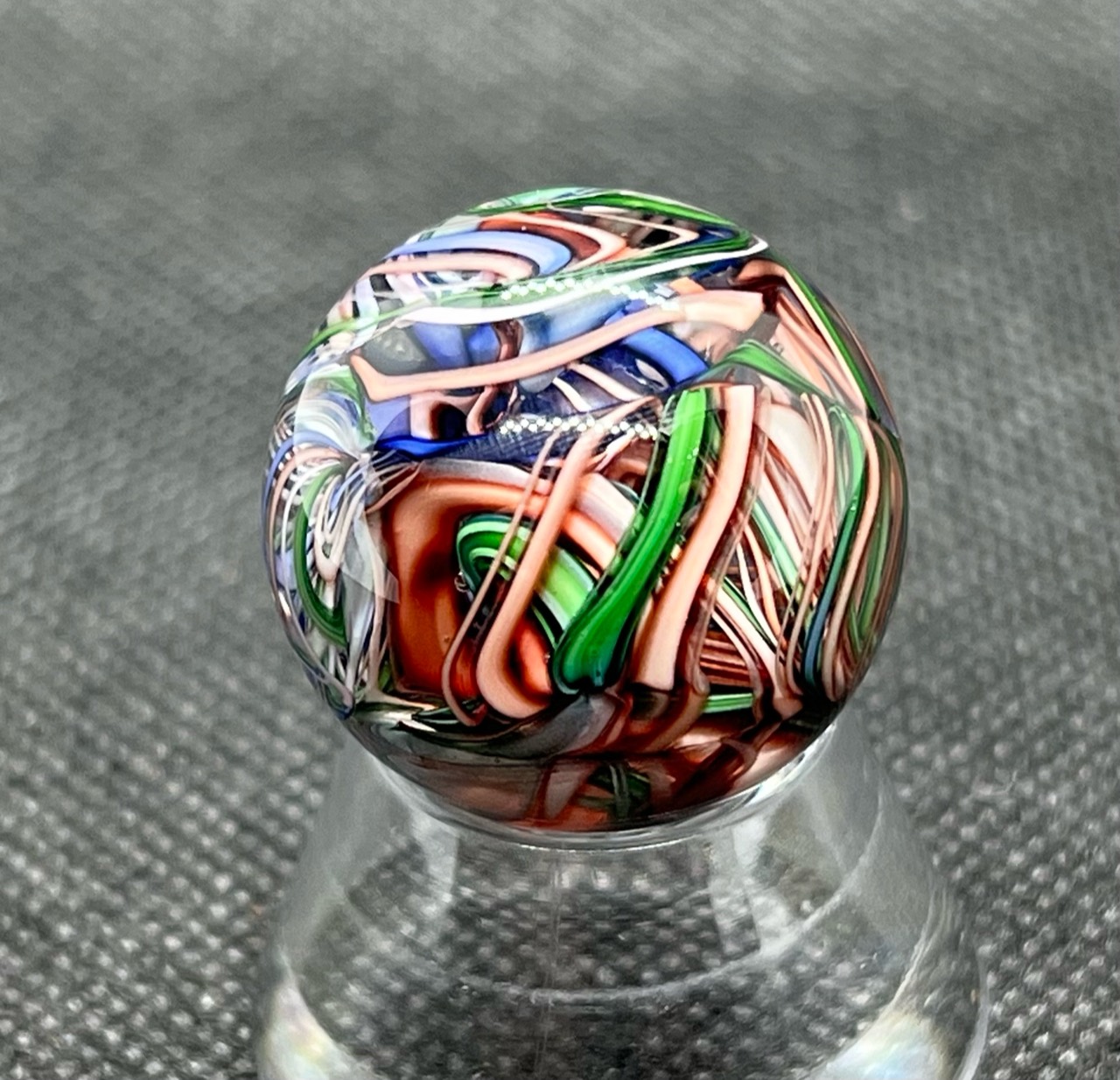 Green, Pink & Blue Ribbon Pocket Marble: Rotated view of upright green and peach-pink folds beneath blue ribbons
