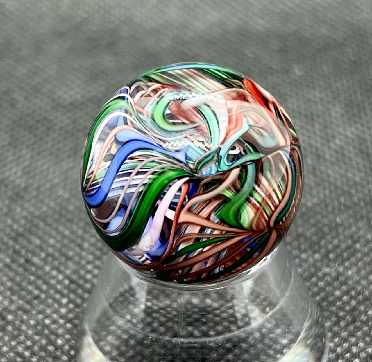 Green, Pink & Blue Ribbon Pocket Marble: Full view of sweeping blue and green ribbons interwoven with pale pink strands