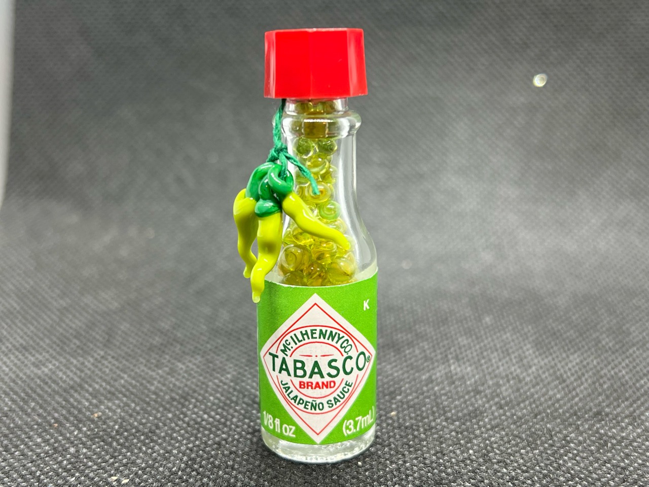 Green Tabasco Mini Micro Marbles: Finished Green Tabasco miniature bottle filled with micro marbles and a hanging pepper bunch