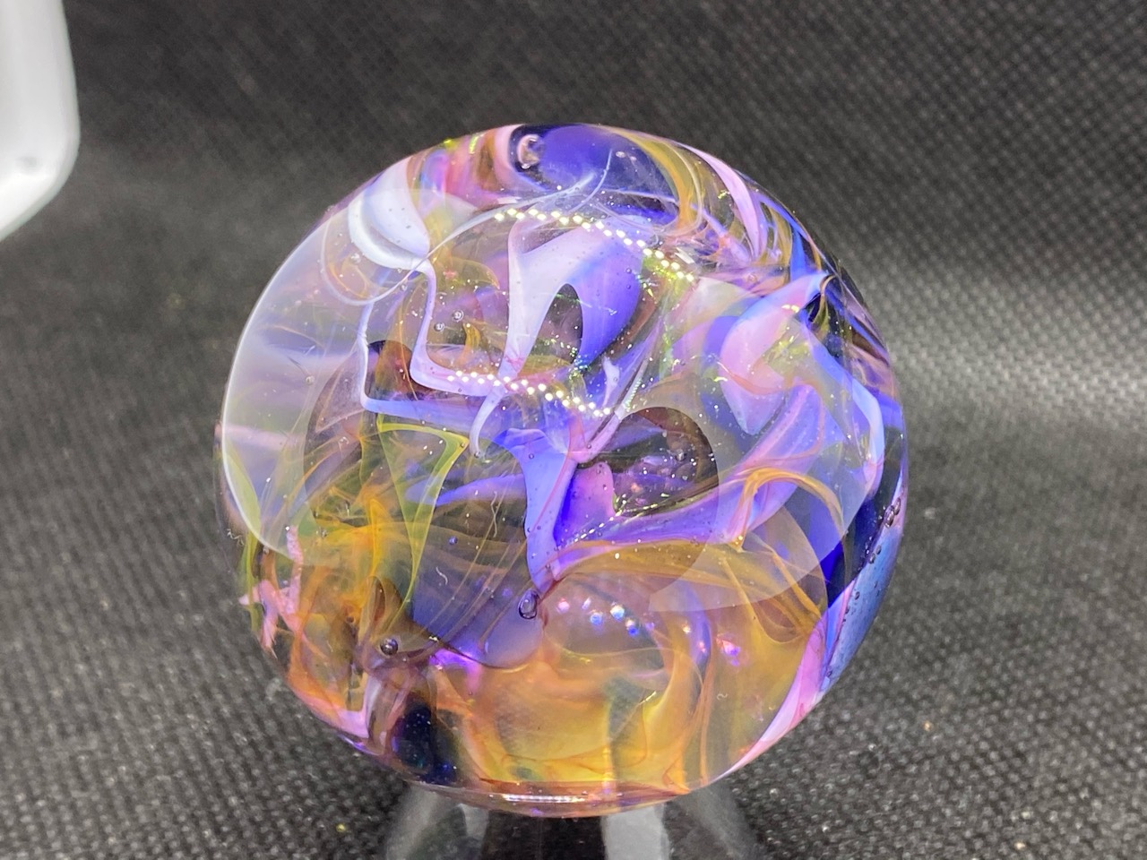 Layered Gold Fume Marble: Studio view of overlapping lavender, pink and amber-colored folds