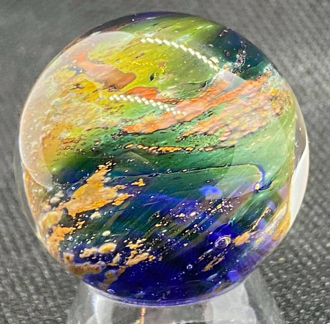 Living Planet Marble (May 7, 2021): copper-colored bands crossing green and cobalt-blue layers