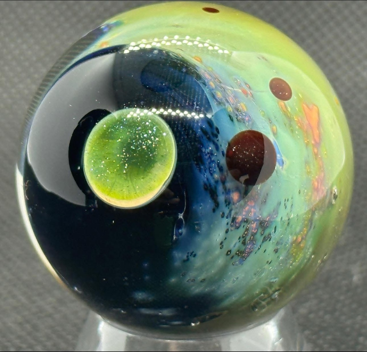 Living Planet Space Marble (2022): bright green planet against a deep blue field