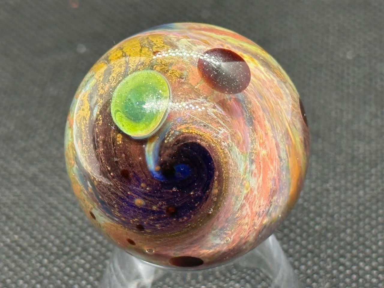 Living Planet Space Marble: blue spiral beside a bright green planet