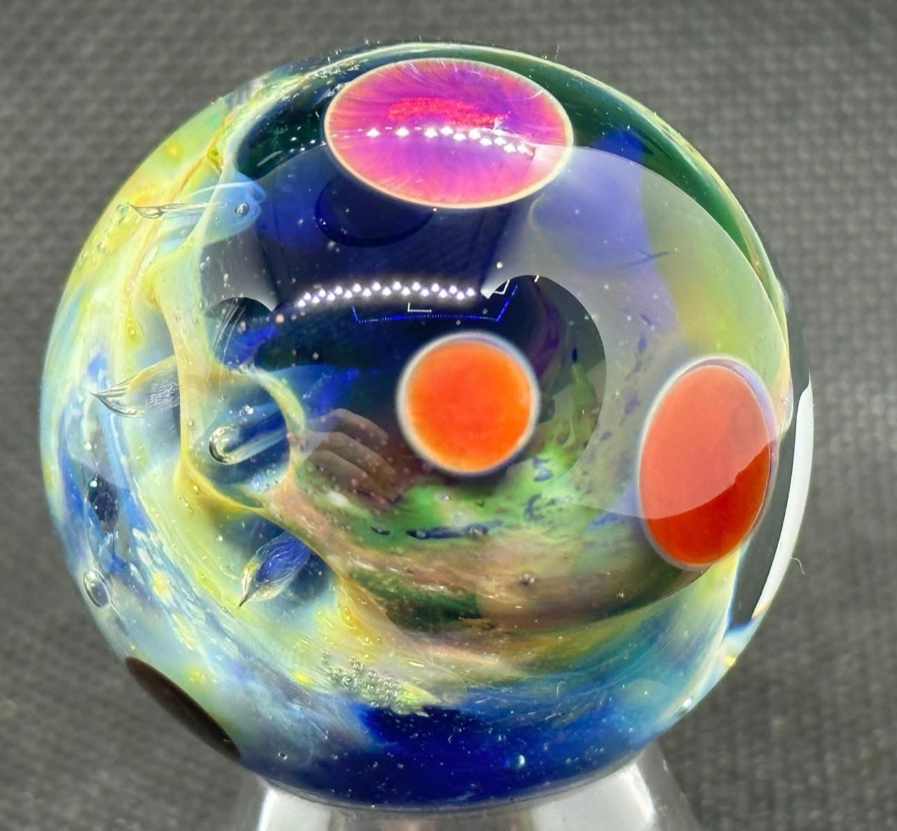 Living Planet Space Marble #6 (2023): pink and orange planets above a deep blue and green glass field