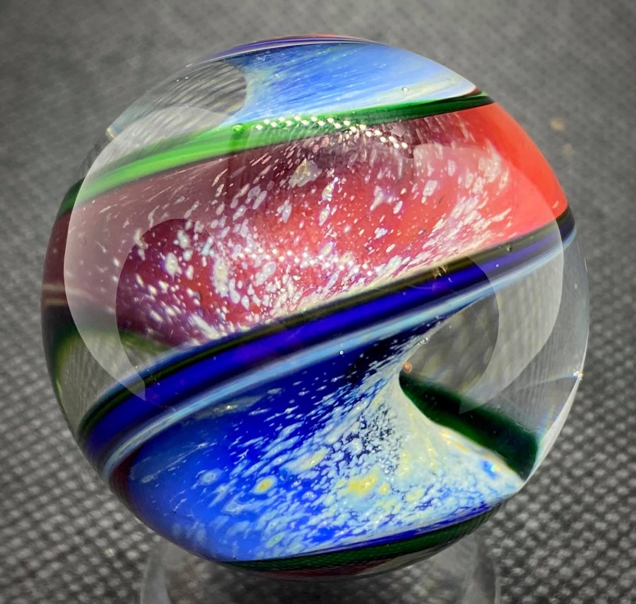 Parallel Dimension of Space Marble: blue and red-pink dimensions filled with pale cloud formations between narrow colored bands