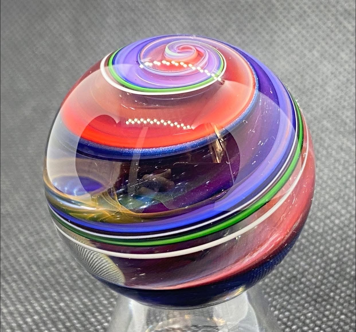 Parallel Dimensions of Space Planet Marble: red and lavender spiral above a clear space window edged in green and white