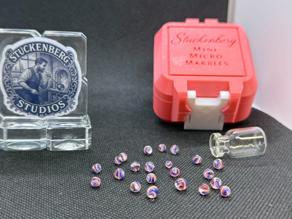 Pink Not Pink Mini Micro Marbles beside their glass jar, pink case and Stuckenberg Studios display