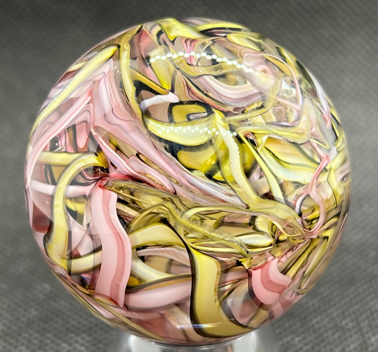 Pink & Yellow Ribbon Marble: Close view of overlapping pink and yellow ribbons with fine dark edges