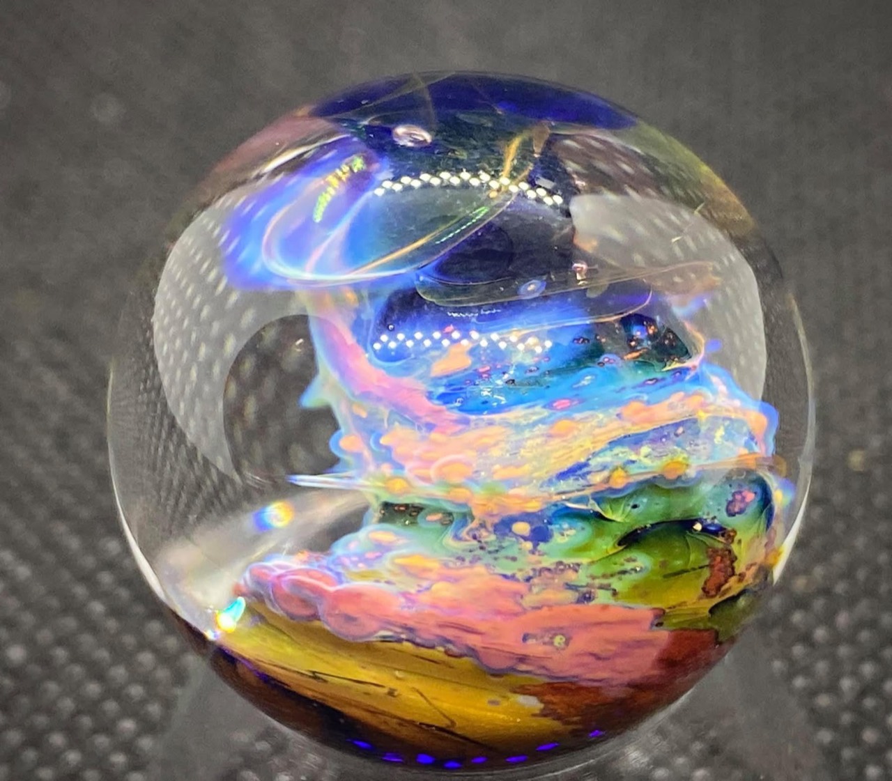 Planetary Nebulas Pocket Marble: electric-blue wisps above layered pink, yellow and green formations