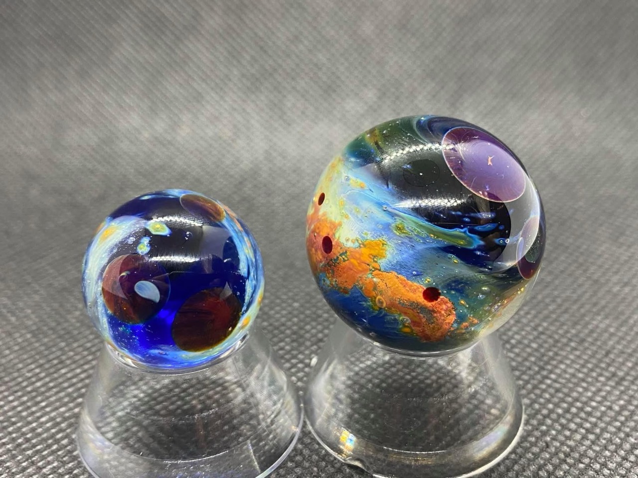 Planetary Space Pocket Marbles (June 20, 2020): both pocket marbles with purple planets, deep blue glass and orange formations