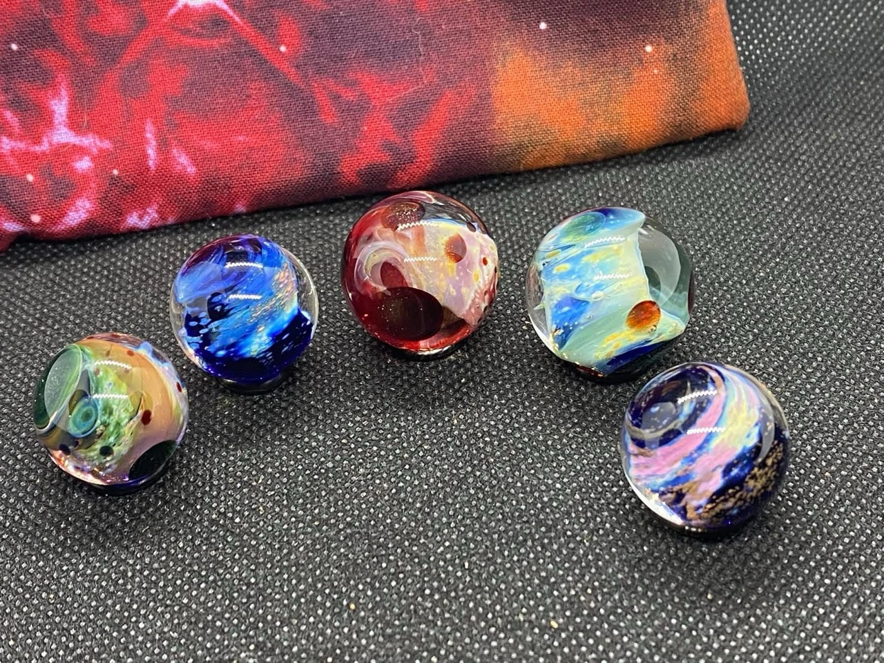 Planetary Space Pocket Marbles — Set #4: complete set of five pocket marbles with blue, pink, gold and red formations