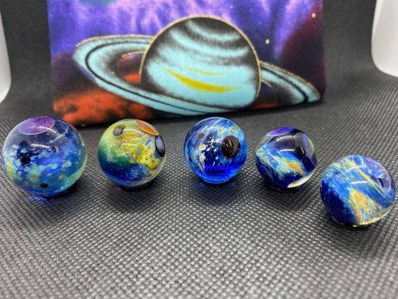 Planetary Space Pocket Marbles — Set #7: complete set of five blue and green pocket marbles in a row