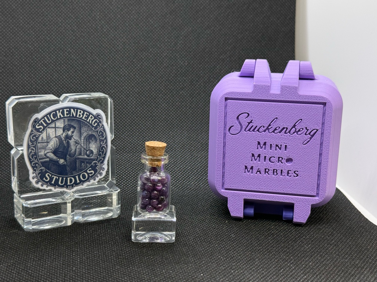 Alternate full display of Purple Dream Mini Micro Marbles in their corked jar beside the purple hard case