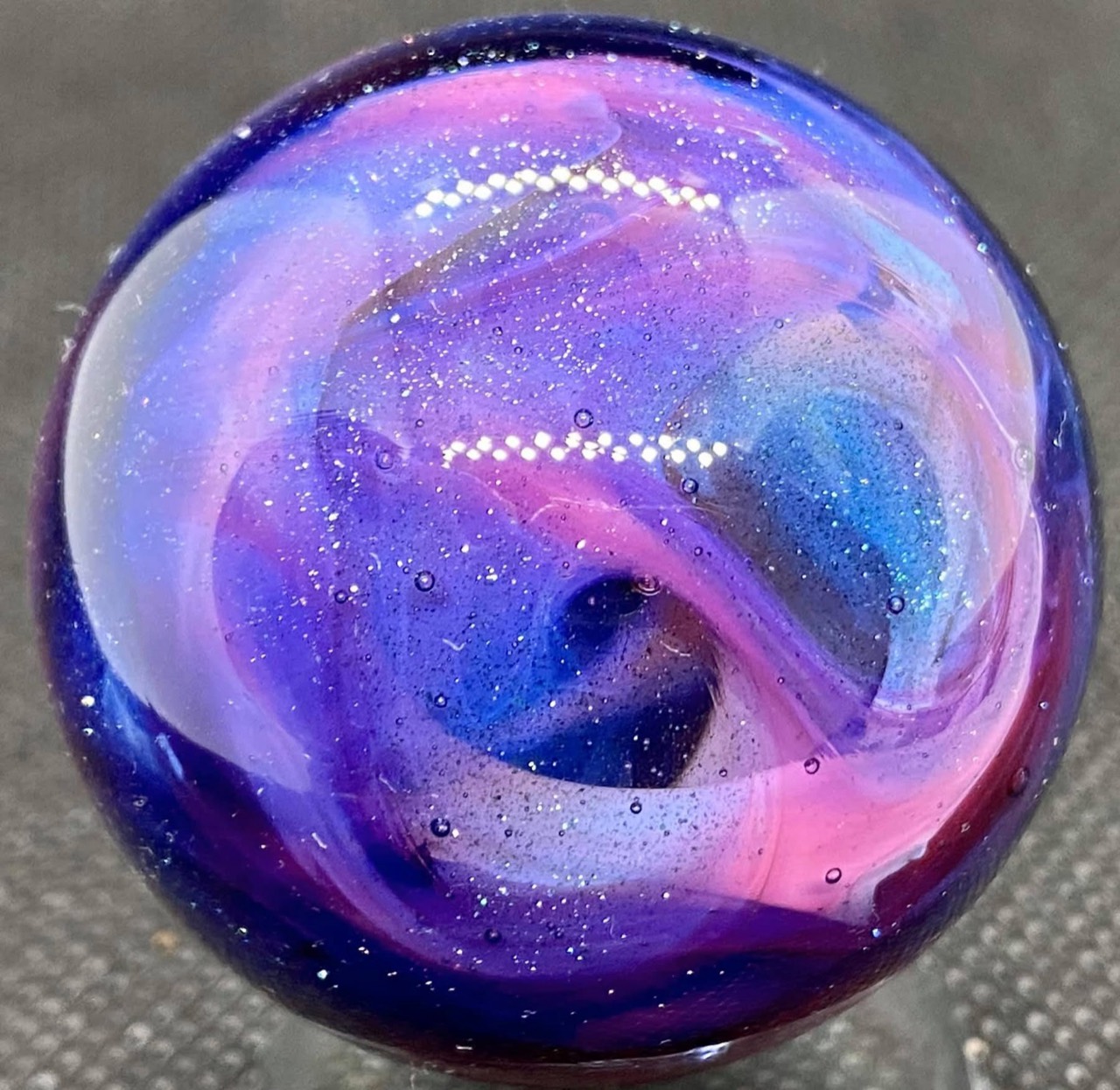 Purple & Pink Glitter Ball Marble: sweeping purple and pink curls with blue accents and fine sparkle