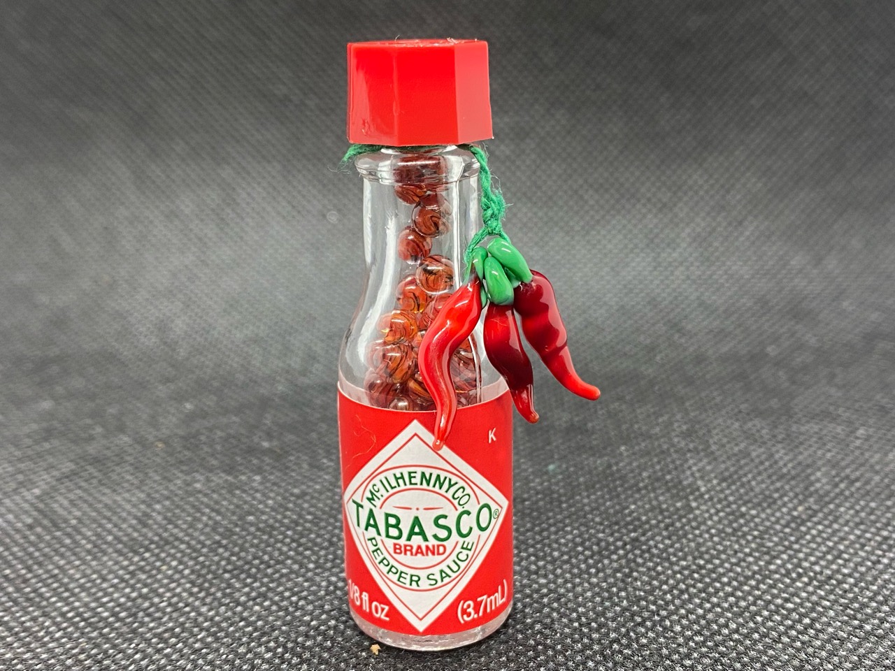 Red Chili Tabasco Mini Micro Marbles: Finished miniature Tabasco bottle of red chili micro marbles with a hanging red pepper decoration