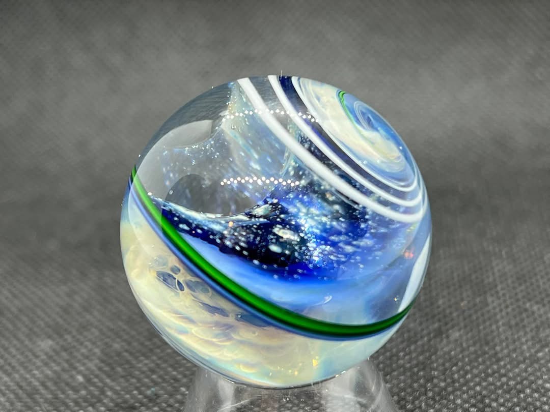Ribbon Twist and Space Marble: blue star fields and pale clouds framed by green bands and white spiral ribbons