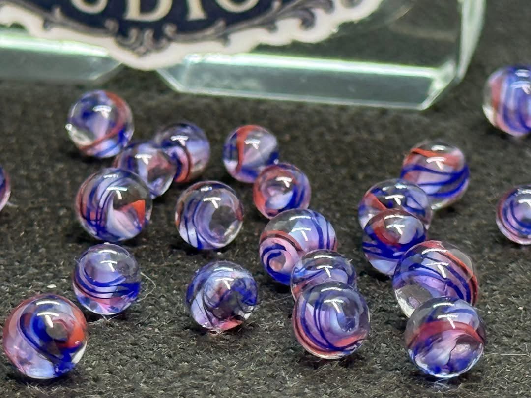 Soft Pink Mini Micro Marbles: close view of soft pink and lavender glass with fine blue ribbons