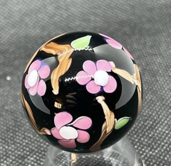 Spring Cherry Blossoms Marble — 2022: front view of three cherry blossoms against the glossy transparent charcoal base