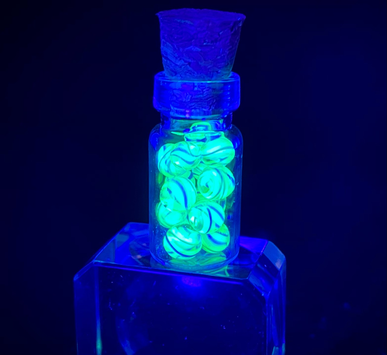 UV White and Blue Uranium Mini Micro Marbles — 2021: corked vial of micro marbles glowing brilliant green under black light