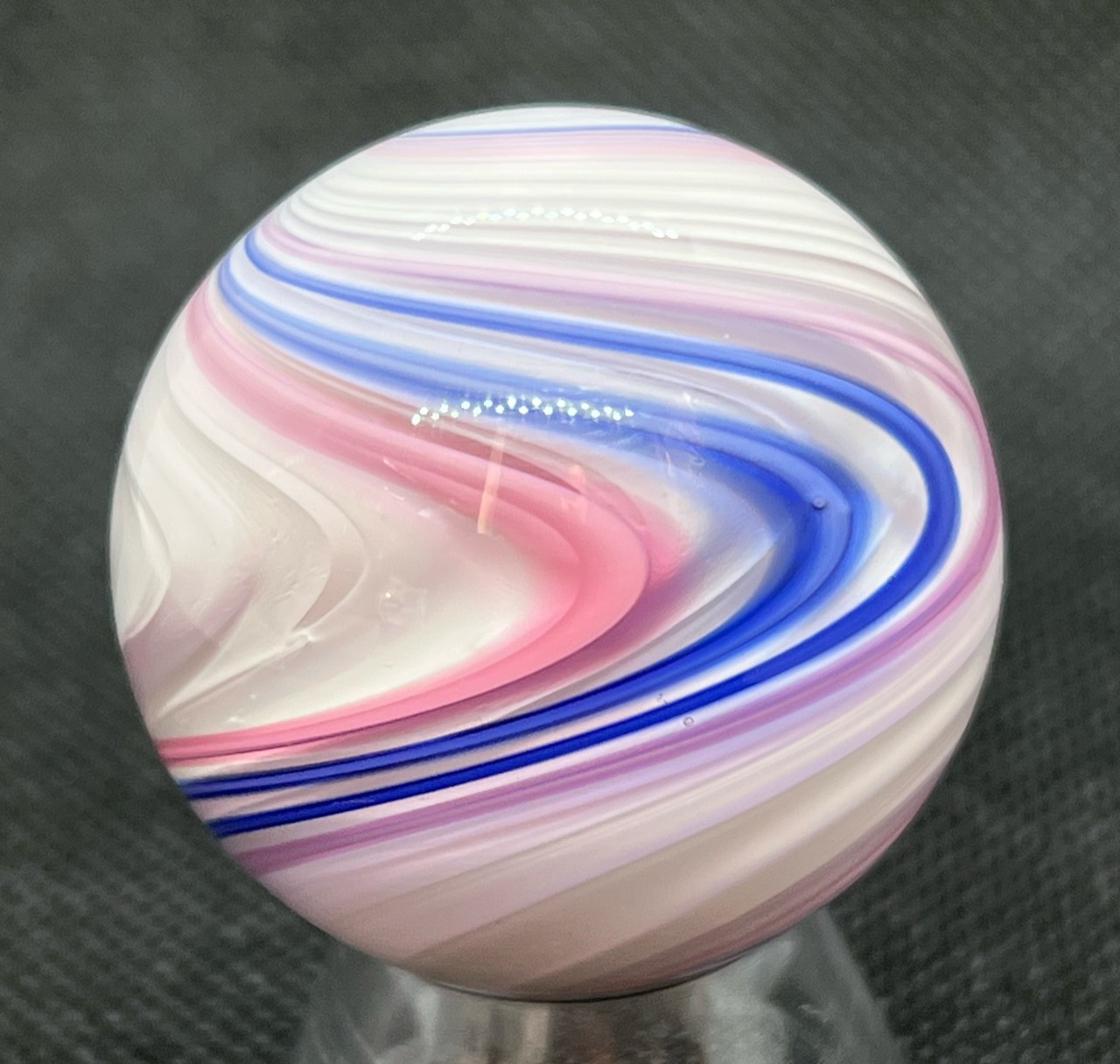 White, Pink & Cobalt Ribbon Marble: Close side view of sweeping white, pink, lavender and cobalt blue ribbons