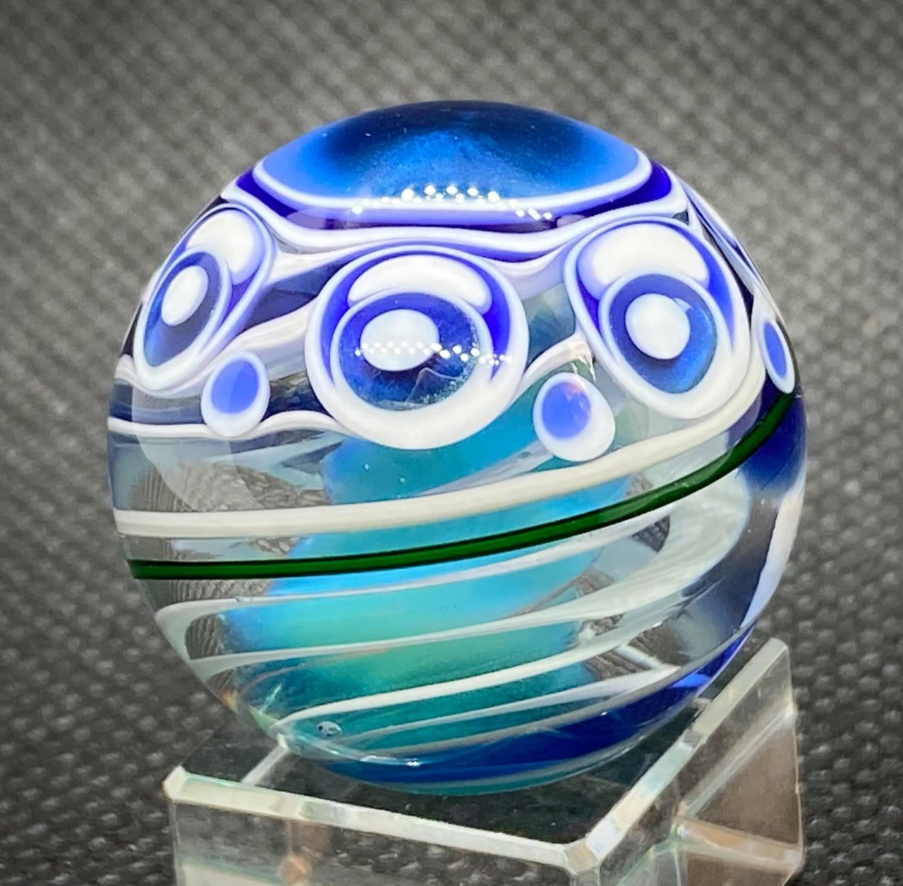 Winter Metallic Blue Dot Stack with Cobalt Blue: angled view of snowy white dot stacks above the cyan core and green ribbon